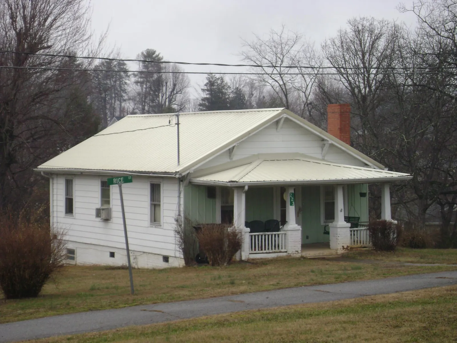 White metal roof on a craftsman bungalow at a street corner in Kingston Mines
